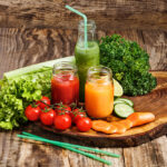 Glass of healthy green juice with fruits and vegetables